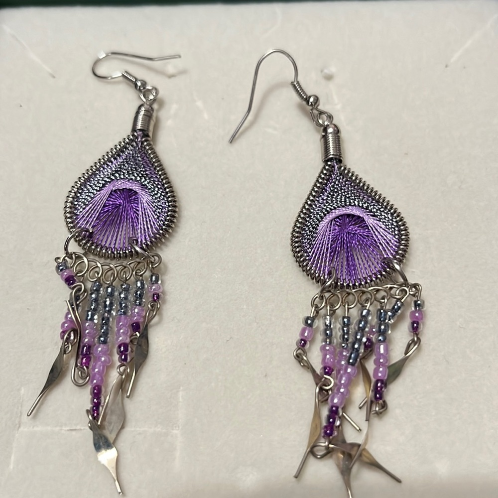 Small purple decorative earrings with dangling charms